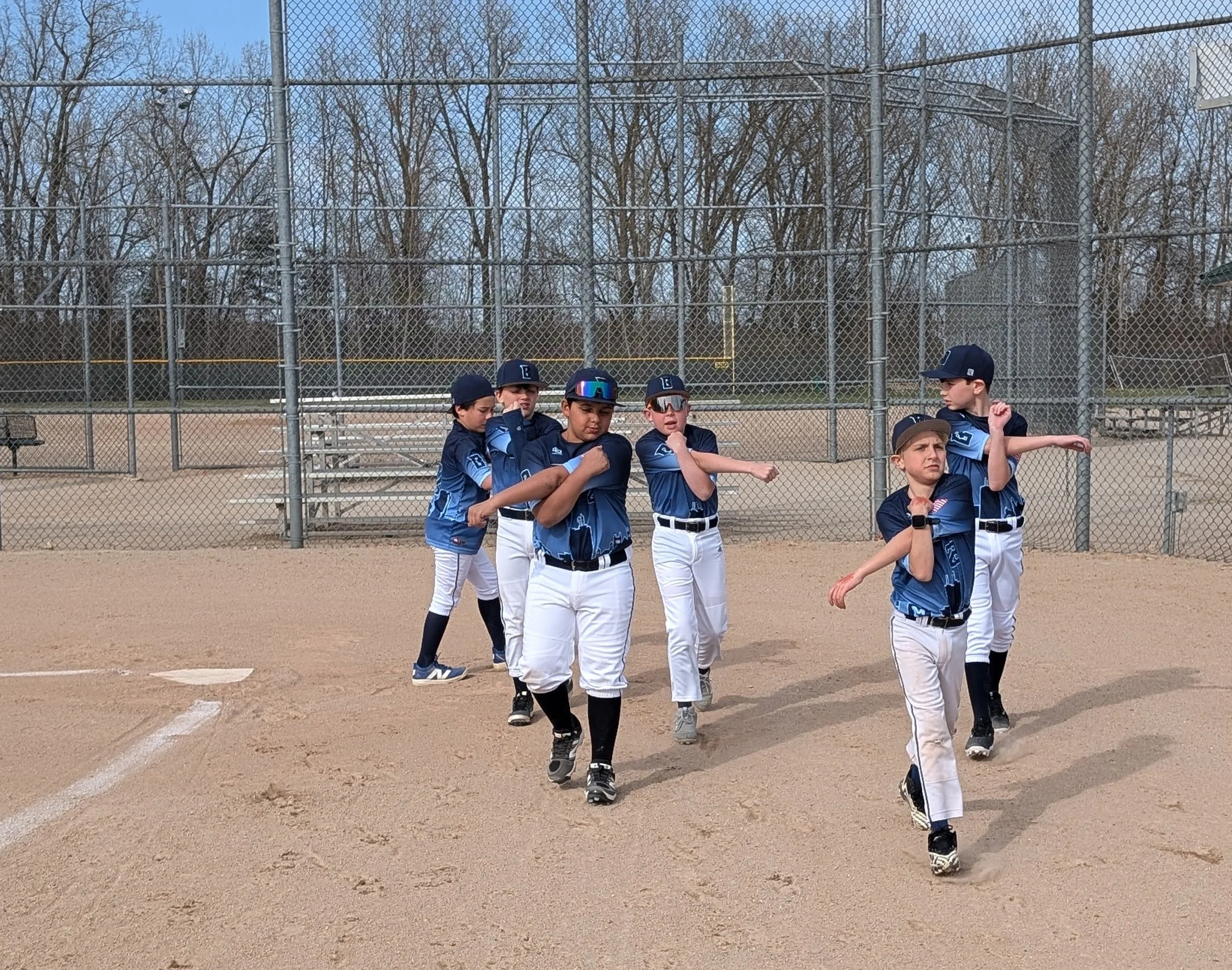 Bombers players warming up their arms in a throwing progression