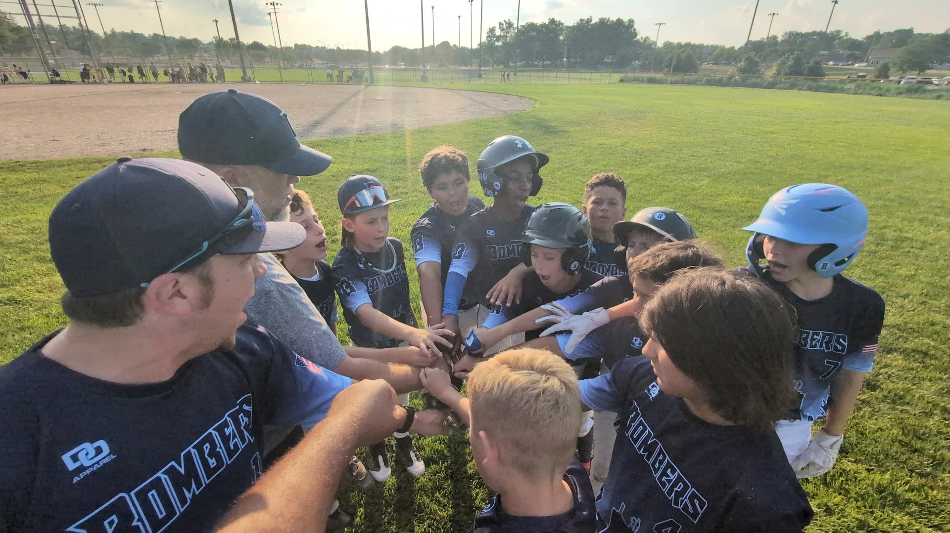 Bombers players in a team huddle on the field